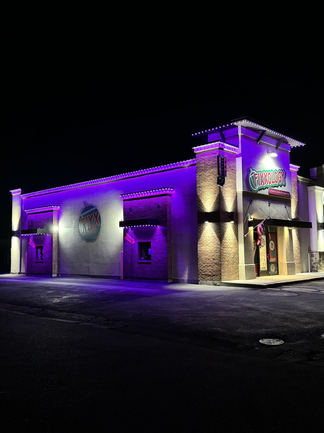 Restaurant building washed in purple permanent lighting at night
