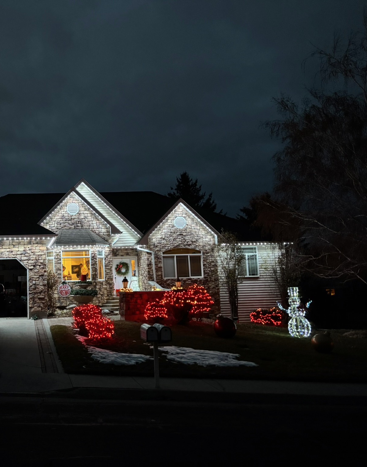 Roofline accent lighting on a stone and siding home